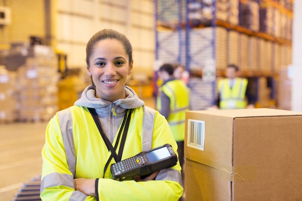A woman working in distribution smiling at the camera